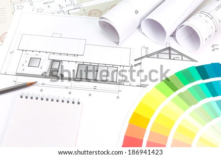 Architect\'s and designer\'s work space during work with technical drawing and color samples catalog
