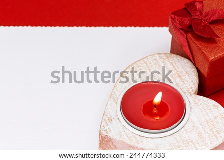 Valentine day greeting card with red gift box and heart shaped candle