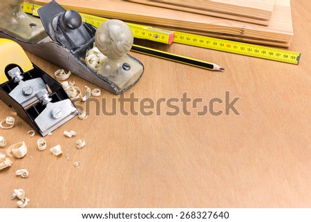 Set of carpenter working tools on wood and shavings