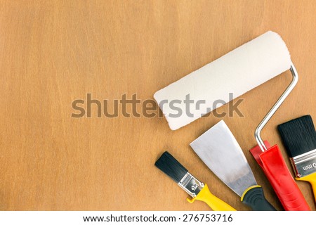 painting tools and accessories for home renovation on wooden background