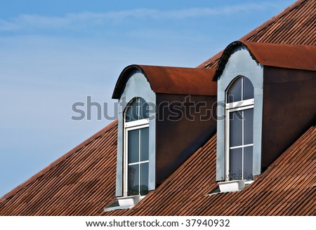 Dormer windows and red tiled metal rooftop