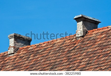 Red tiles and chimney on a house roof