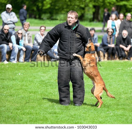 AMSTERDAM - MAY 13: An unidentified park ranger demonstrates dog training skills during the Start of the outdoor season in Amsterdam forest, held on May 13, 2012, Amsterdam, The Netherlands