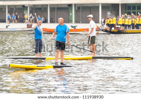 AMSTERDAM - SEP 2: Unidentified city natives participate in stand up paddle surfing (SUP) clinic, held during Dutch Paddling Championships, on September 2, 2012, Bosbaan, Amsterdam, The Netherlands