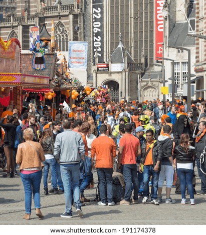 AMSTERDAM - APRIL 26: Unidentified city natives and tourists celebrate King\'s Day, Dutch annual national holiday, at the city\'s Dam Square, on April 26, 2014 in Amsterdam, The Netherlands