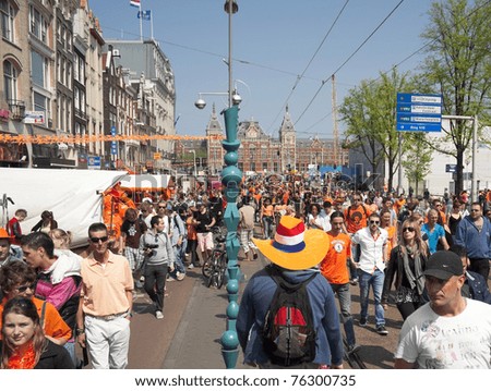 AMSTERDAM - APR 30: City natives and tourists celebrate Queen\'s Day, Dutch annual national holiday, in the streets of the city, April 30, 2011, Amsterdam, The Netherlands