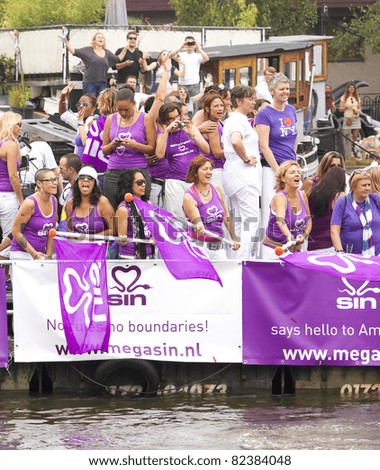 AMSTERDAM - AUG 6: Rotterdam natives and guests on board of MegaSIN boat participate in the Canal Parade, held during Amsterdam Gay Pride week, August 6, 2011, Amsterdam, The Netherlands