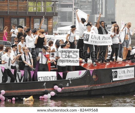 AMSTERDAM - AUG 6: Students on board of University of Amsterdam boat participate in the Canal Parade, held during Amsterdam Gay Pride week, August 6, 2011, Amsterdam, The Netherlands
