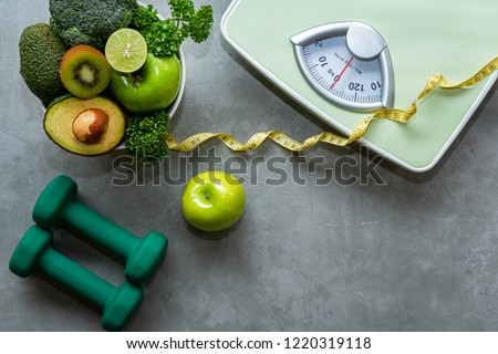 Diet and Healthy life loss weight slim Concept. Organic Green apple and Weight scale measure tap with nutrition vegan vegetable and sport equipment gym for body women diet fit.  Top view copy space.   Foto stock © 