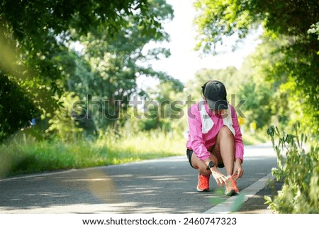 Similar – Image, Stock Photo Sporty woman tying laces on sneakers before training