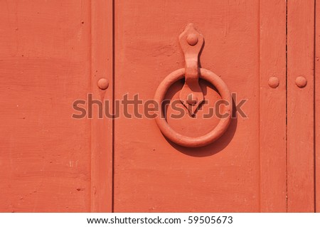 Red painted old iron door with circle door-handle