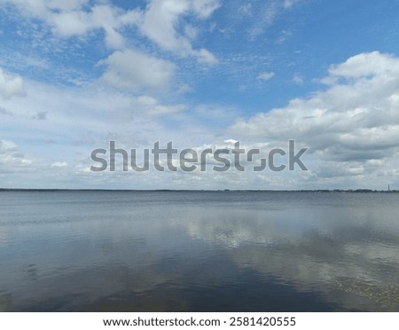 Similar – Image, Stock Photo Sunset sky over wavy sea with floating boats