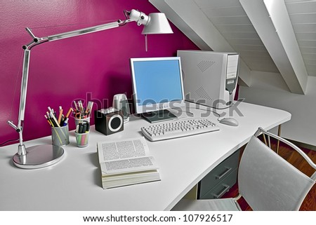 modern desk in the attic with computer and book opened
