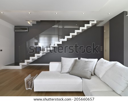 fabric sofa in the modern living room with staircase and wood floor
