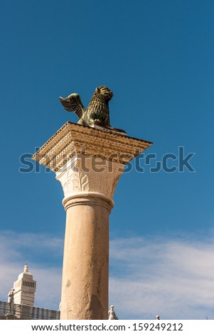 winged lion symbol of Venice in Saint Mark place in Venice with many monuments