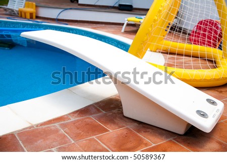 A good shot of a pool with diving board