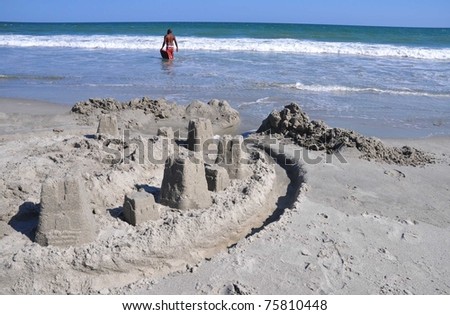 Beach scene with ocean and sandcastle