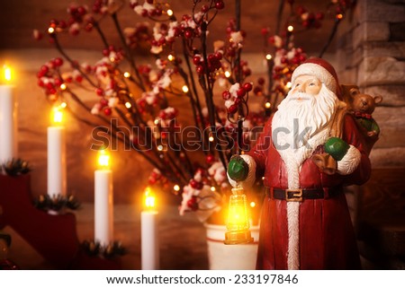Wooden sculpture of Father Frost with a small lamp