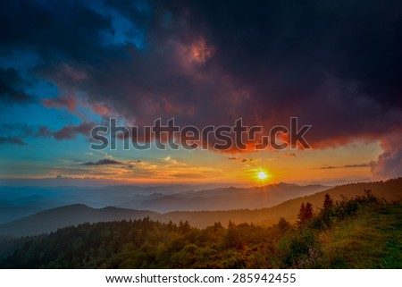 The light over the Appalachian Mountains along the Blue Ridge Parkway in Western North Carolina paints the sky with the setting sun.