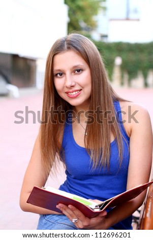 Caucasian student on the bench reading book