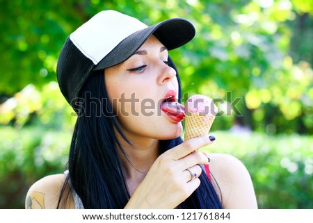 Portrait of sexy brunette grunge young woman who eating ice cream