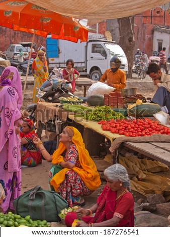 JAIPUR, INDIA - MARCH 26, 2014: Traders and customers in the fruit and vegetable market in the old Johari Bazaar district of the city