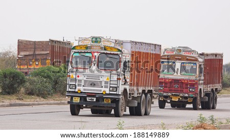RAJASTHAN, INDIA - MARCH 26, 2014: Trucks on the Jaipur to Delhi highway. India has the second largest network of roads in the world and its economy is dependent upon the movement of goods by road