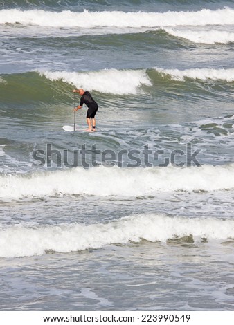 WESTWARD HO! - ENGLAND - OCTOBER 3, 2014: A sea boarder riding the waves off the North Devon coast which is popular with surfers and boarders alike