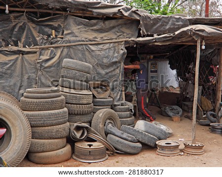 MADHYA PRADESH, INDIA - FEBRUARY 28, 2015: A tire replacement service at a village truck stop. The vast numbers of motor vehicles in are served by many such such small businesses across the country