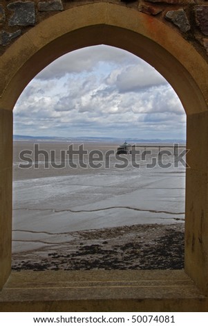 The Bristol Channel and Clevedon Pier viewed through an arched window on a blustery winter\'s day