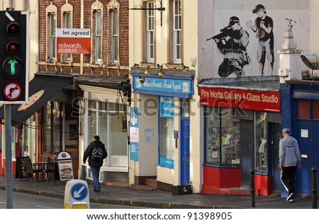 BRISTOL, ENGLAND - FEBRUARY 26: Police sniper by Banksy in Upper Maudlin Street in Bristol, England on February 26, 2011. The image has since been overpainted, allegedly by a rival artist