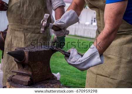 Similar – Image, Stock Photo Blacksmith forging horseshoe near stable