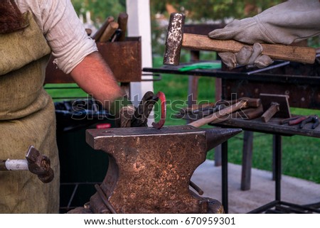 Similar – Image, Stock Photo Blacksmith forging horseshoe near stable