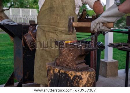 Similar – Image, Stock Photo Blacksmith forging horseshoe near stable