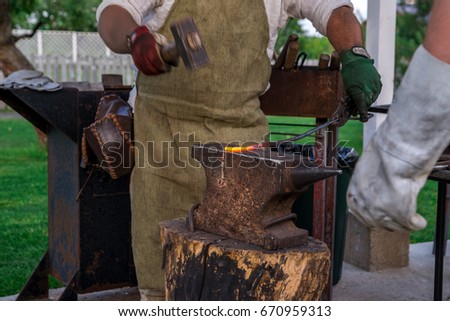 Similar – Image, Stock Photo Blacksmith forging horseshoe near stable