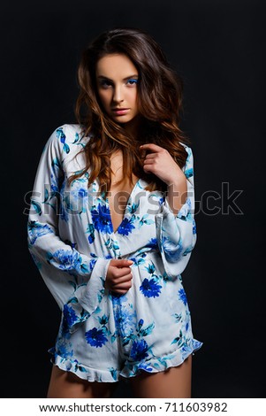 Portrait Of An Attractive Brunette Woman Wearing A White Nightshirt In Front Of Black Studio Portrait Of An Attractive Brunette Woman Wearing A White Nightshirt In Front Of Black Studio