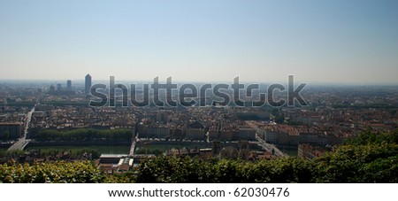 We can see a landscape of Lyon seen from the hill of the basilica fourvi?re, we see the rhone, many buildings and roads.