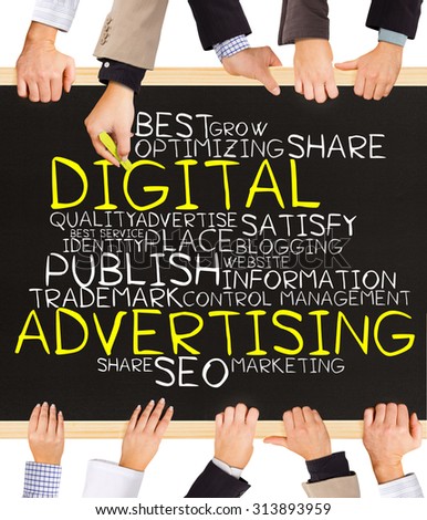 Photo of business hands holding blackboard and writing DIGITAL advertising word cloud