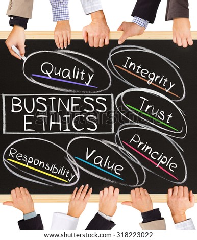 Photo of business hands holding blackboard and writing BUSINESS ETHICS diagram