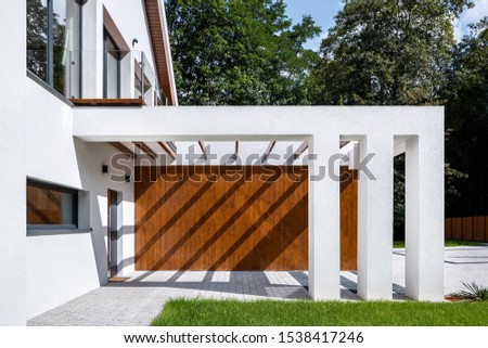 Elegant house with modern designed entrance with wooden elevation and white pillars ストックフォト © 