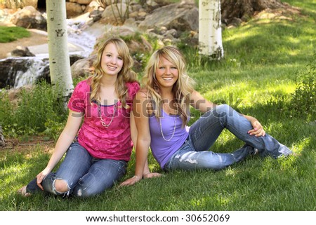 Two teenage girls posing for a portrait in scenic area