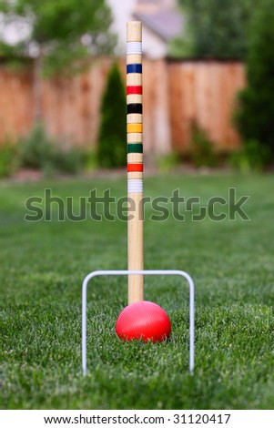 game of croquet off center in back yard