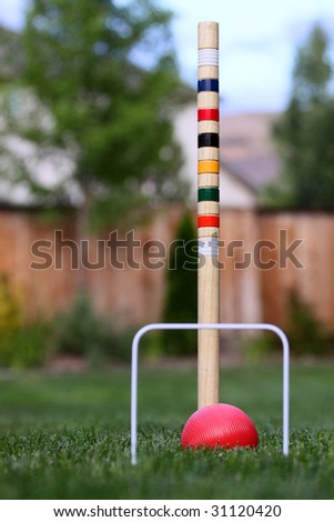 game of croquet off center in back yard