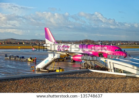 GDANSK AIRPORT, POLAND - JANUARY 13: WizzAir plane being loaded at Lech Walesa Airport in Gdansk on Jan. 13, 2012. The terminal was expanded and enlarged to handle air traffic for soccer Euro Cup 2012