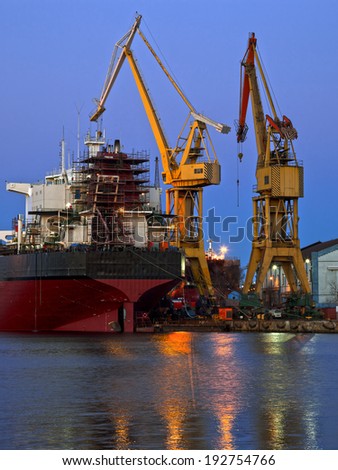 Industrial shipyard yellow crane at night.