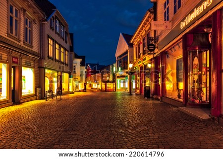 STAVANGER, NORWAY - JULY 14: Typical Norwegian street with many shops in the old town center at night scenery, on July 14, 2011 in Stavanger, Norway. Stavanger is Norway\'s fourth largest city.