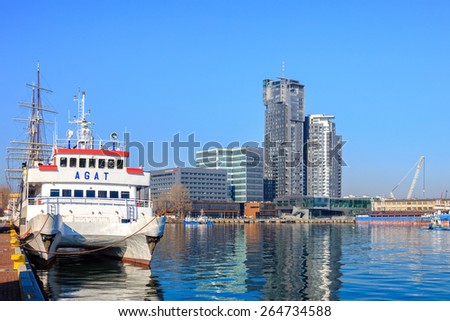 GDYNIA,POLAND-MARCH 18:White Passenger Ship moored in the port on the background of the city of Gdynia on March 18, 2015 in Gdynia, Poland.Gdynia is a port city, the organizer of the Tall Ships\' Races