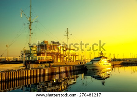 SOPOT, POLAND - APRIL 10: Marina with yacht boat and calm in early morning light on wooden pier, on April 10, 2015 in Sopot, Poland. Pier is a very popular tourist attraction in Sopot.