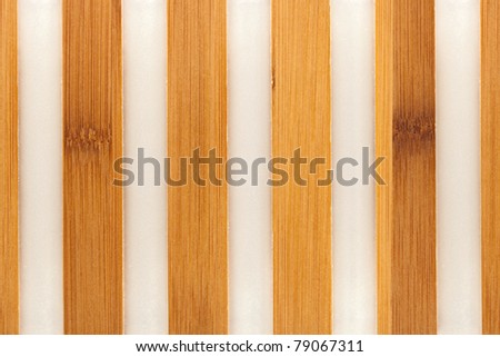 Texture of wooden strips embedded in the plastic.