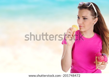 Young pretty girl with ice cream on sandy beach.